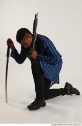 Man Adult Average Black Kneeling poses Casual Fighting with shotgun